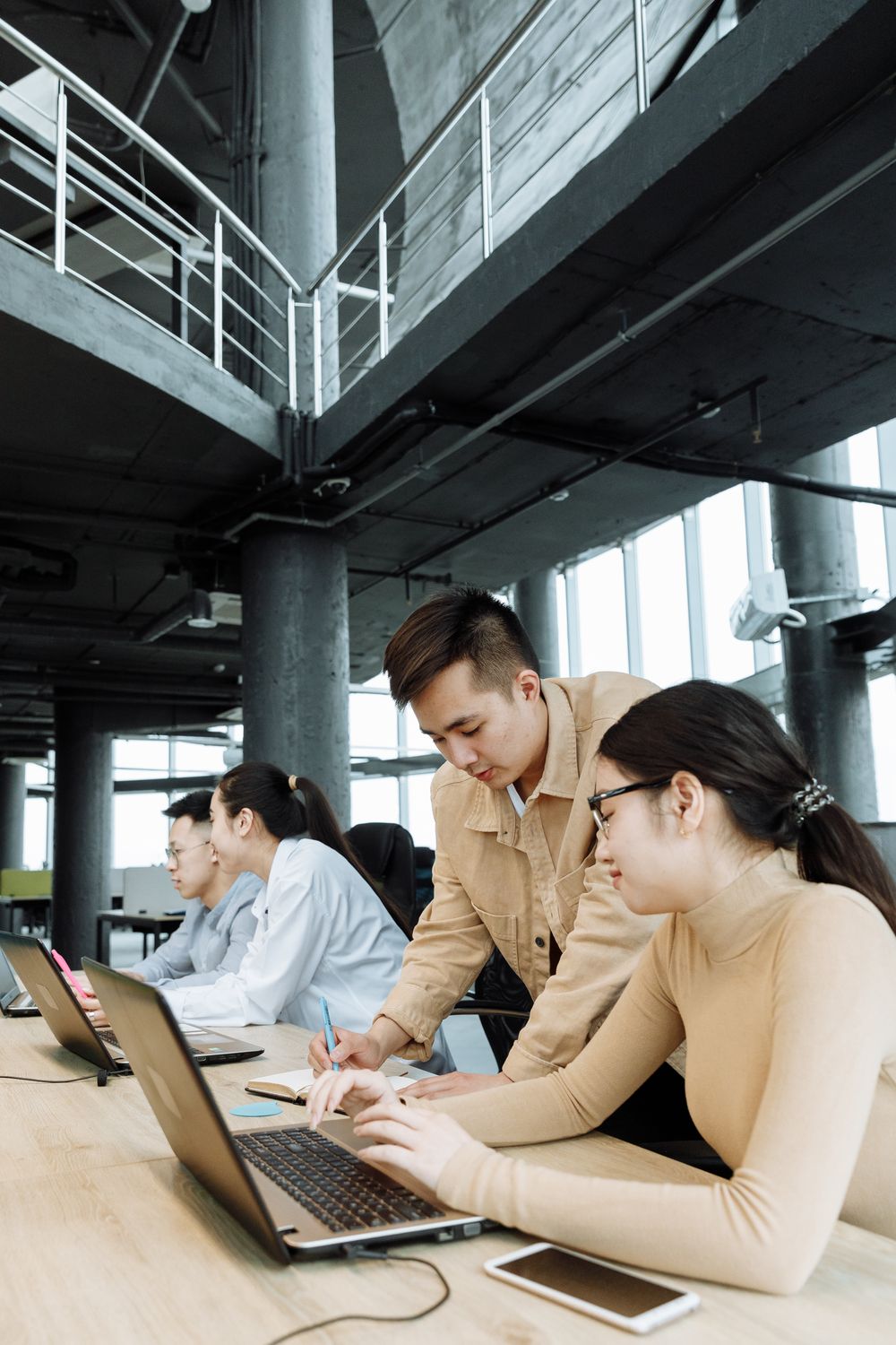 Professionals working together with laptops in an office